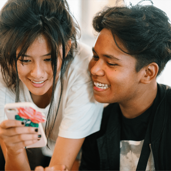 Teen looking at mobile phone.