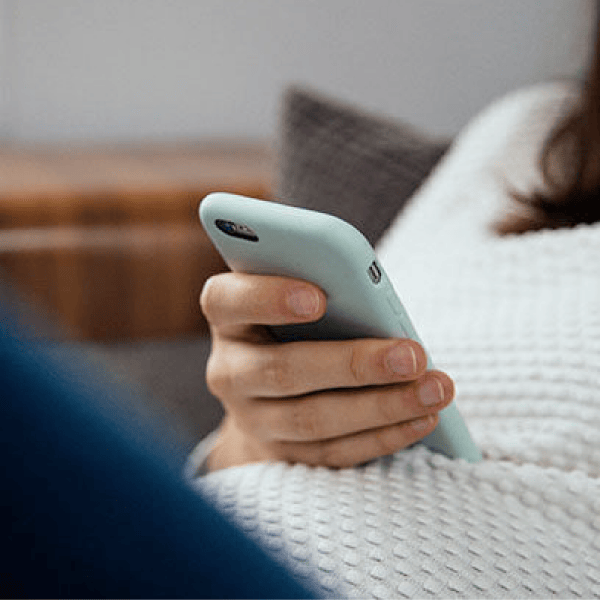 Person holding a mint colored mobile phone