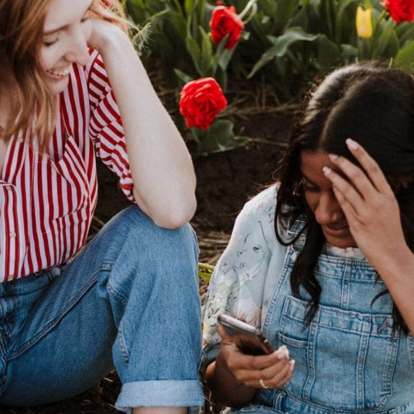 Teens looking at mobile phone.