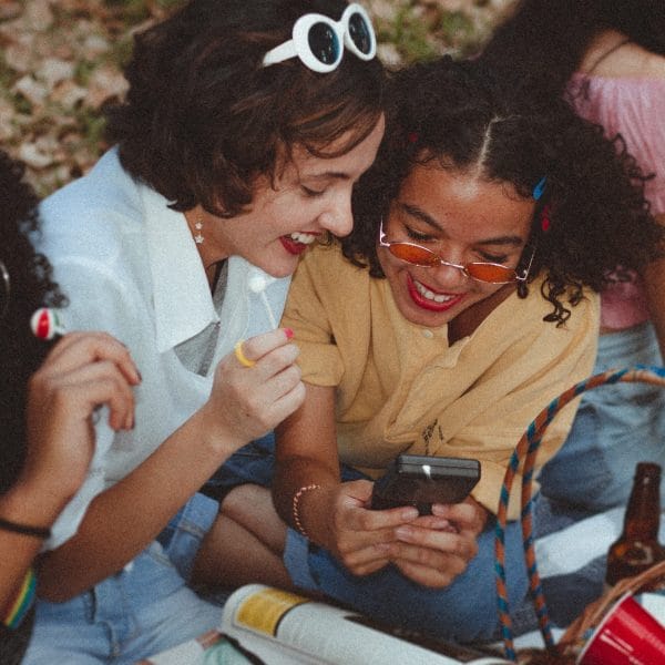 Teens looking at mobile phone.