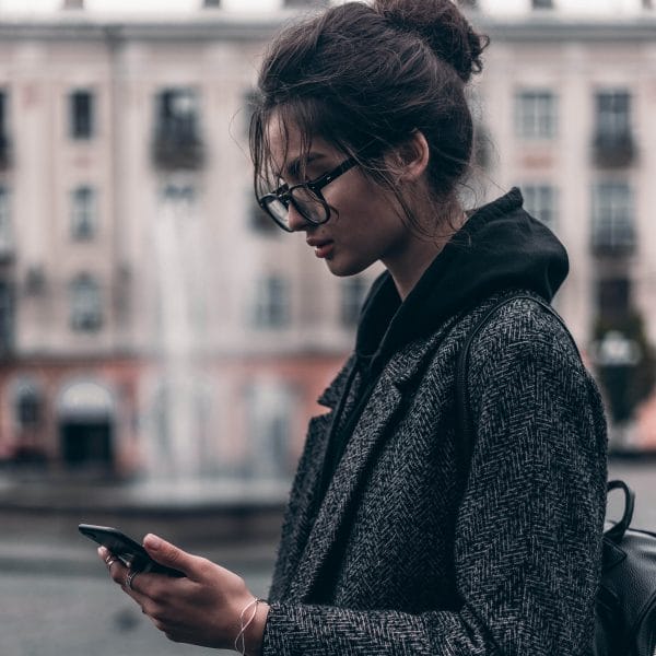 Teen looking at mobile phone.
