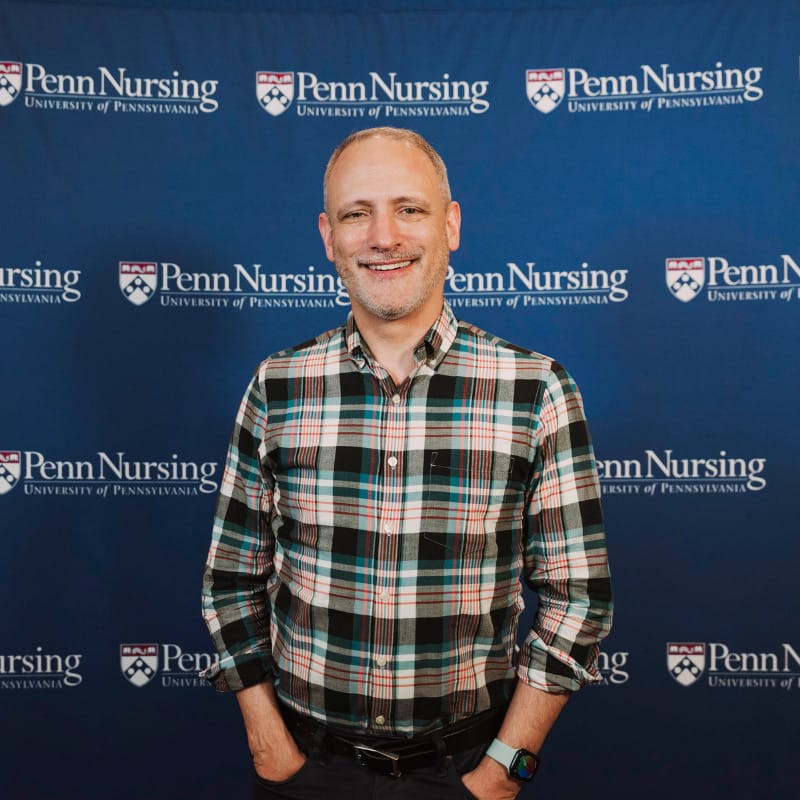 Fred Dillon in front of Penn Nursing Step and Repeat