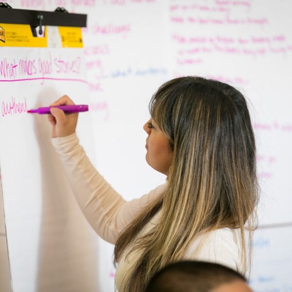 person writes on a whiteboard