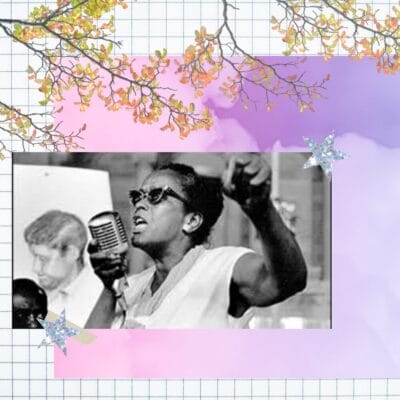 Ms Ella Baker wearing sunglasses at a rally on a background of pink and purple 