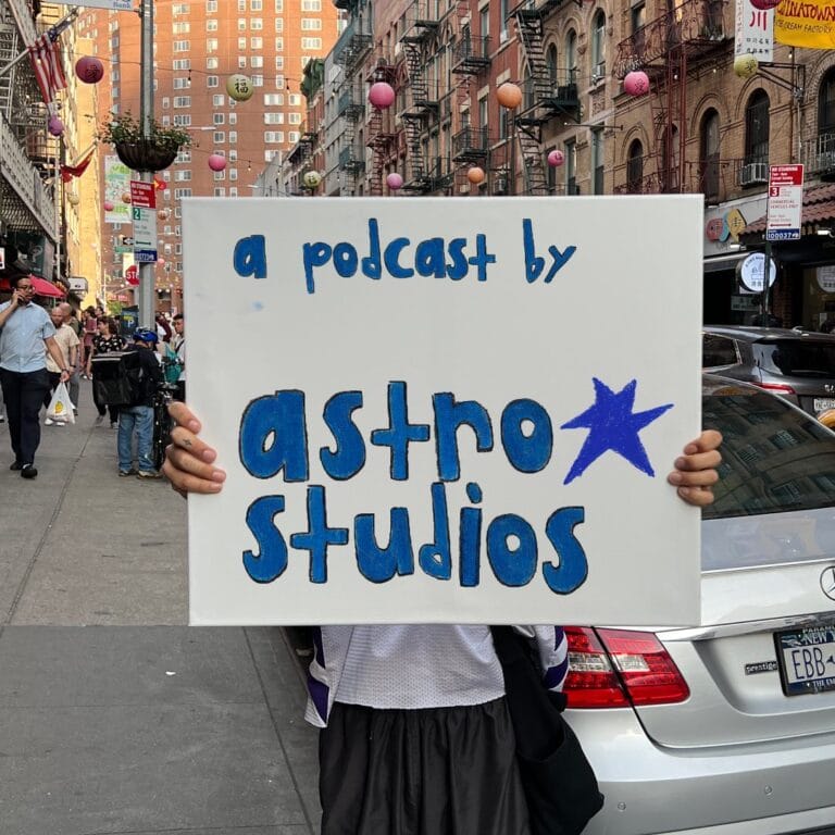 A podcast by astro studios written on a sign