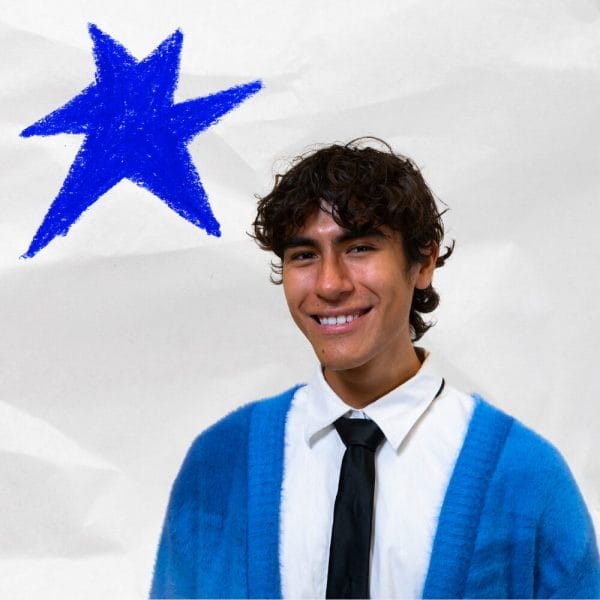headshot of Gael Aitor wearing a blue sweater and black tie